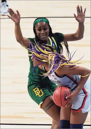  ?? Eric Gay / Associated Press ?? UConn forward Aaliyah Edwards, right, is pressured by Baylor center Queen Egbo, left, as she tires to score during their game in the Elite Eight on Monday.