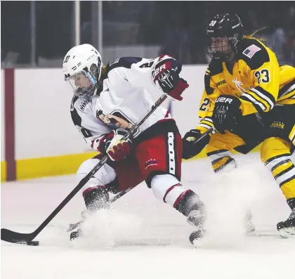  ?? JEWEL SAMAD/AFP/GETTY IMAGES ?? New York Riveters forward Brooke Ammerman, left, dodges Boston Pride forward Corinne Buie in a game during the inaugural season of the National Womens Hockey League in Brooklyn, N.Y. Players have said they won’t suit up next season in an economic boycott.