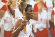  ?? PETER LEABO AP ?? Decathlon champion Rafer Johnson carries the torch toward the caldron at the 1984 Olympics in Los Angeles.