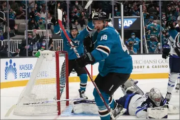  ?? PHOTOS BY SHAE HAMMOND — BAY AREA NEWS GROUP ?? The San Jose Sharks’ Tomas Hertl (48) celebrates with Jasper Weatherby (26) after scoring a goal against the Winnipeg Jets in the third period at the SAP Center in San Jose on Saturday.