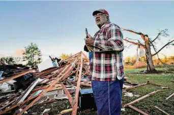  ?? LM Otero/Associated Press ?? Fred Davis talks to his daughter on a cell phone as he describes how a tornado splintered his home in Powderly, Texas. Tornadoes also smashed homes across the state line in Oklahoma.