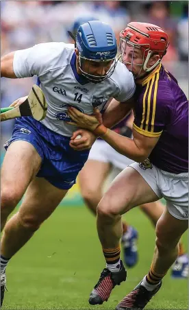  ??  ?? Waterford stalwart Michael ‘Brick’ Walsh bursting past Willie Devereux.