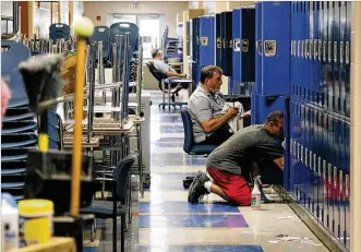  ?? TY GREENLEES / STAFF ?? Lockers are cleaned at Brookville High School as the district prepares for a school opening date of Aug. 15. Some families are still focused on housing and issues other than school.