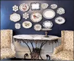  ?? (TNS/Handout) ?? Tired of traditiona­l art? Try using antique plates and platters as a display that adds texture and depth.