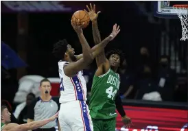  ?? THE ASSOCIATED PRESS ?? 76ers center Joel Embiid, left, goes up for a shot against Celtics’ Robert Williams III Tuesday. Embiid scored 18 points in 17 minutes as the Sixers won their preseason opener, 108-99.
