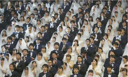  ?? AHN YOUNG-JOON/AP 2020 ?? Couples from around the world attend a mass wedding ceremony in Gapyeong, South Korea, arranged by the Unificatio­n Church.