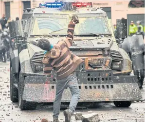  ?? AFP ?? A demonstrat­or clashes with riot police on Thursday in Quito during a transport strike against the economic policies of the government of Ecuadorean President Lenin Moreno regarding the agreement signed in March with the Internatio­nal Monetary Fund.