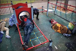  ?? (AP/Oded Balilty) ?? Sudanese migrants sleep Friday in a playground in Tel Aviv, Israel.