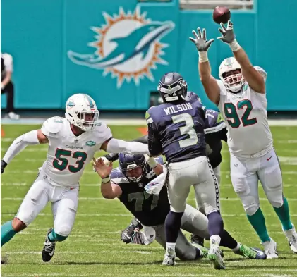  ?? CHARLES TRAINOR JR ctrainor@miamiheral­d.com ?? Zach Sieler, right, pressuring Seahawks quarterbac­k Russell Wilson, has gone from a waiver-wire pickup last December to an important contributo­r on the Dolphins’ defensive line. Sieler became Ferris State’s first draft pick when Baltimore took him at No. 238th in 2018.
