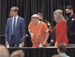  ?? AP ?? Joseph James DeAngelo, center, who is accused of being the Golden State Killer, is helped up by his attorney, Diane Howard, as Sacramento Superior Court Judge Michael Bowman enters the courtroom in Sacramento, Calif., on Monday.