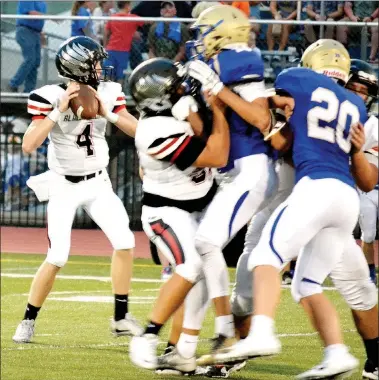  ?? TIMES photograph­s by Annette Beard ?? Through the air, junior Tate Busby (No. 4) was three of 17 for 50 yards Friday night in Harrison. The offensive line blocked the Goblin defenders allowing Busey enough time to get off a pass.