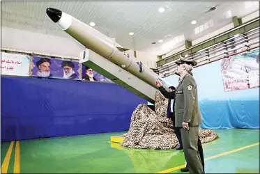  ?? (AFP) ?? A handout picture released by Iran’s Defence Ministry on Aug 13, 2018 shows Defence Minister, Brigadier General Amir Hatami, standing by the next generation short-range ballistic missile ‘Fateh Mobin’, during an unveiling ceremony in the capital Tehran.State broadcaste­r IRIB said the new missile had ‘successful­ly passed its tests’ and could strike targets on land and sea.
