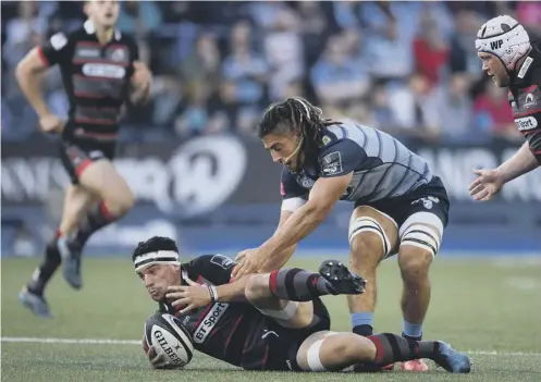  ??  ?? John Hardie of Edinburgh is tackled by Josh Navidi of Cardiff Blues during the visitors’ 20-10 victory at Cardiff Arms Park last night.