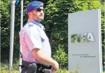  ?? PHILIPP SCHMIDLI/GETTY IMAGES ?? A policeman stands in front of the FIFA headquarte­rs on Wednesday in Zurich, Switzerlan­d.