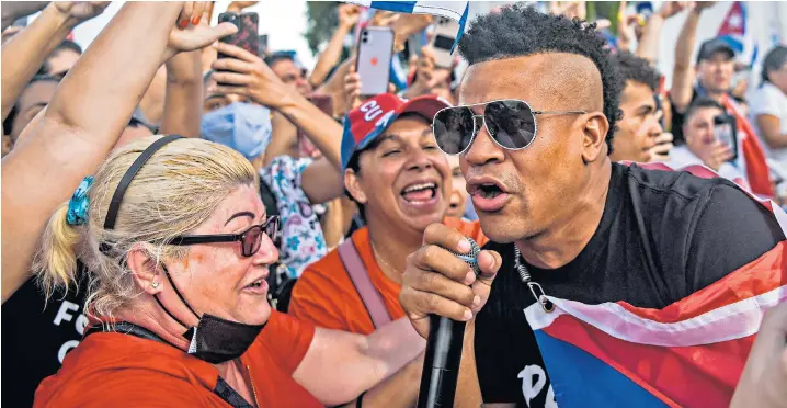  ??  ?? Randy Malcom of Gente de Zona, the group behind protest rap song Patria y Vida, above; Dina Stars, left; and Luis Manuel Otero Alcántara, head of the San Isidro Movement, below