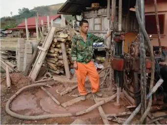  ?? (Reuters) ?? Chinese workers drill for soil analyses at Bopiat village in the Northern province of Louang Namtha