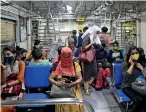  ?? AP ?? Women passengers travel on a local train in Mumbai on Wednesday. The Indian Railways has permitted women passengers to travel in local trains during non-peak hours beginning Wednesday, which otherwise has been running only for essential services. —