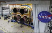  ?? ERIC BORDELON — NASA ?? Technician­s at NASA' s Michoud Assembly Facility in New Orleans install the third and fourth RS-25engines onto the core stage for the agency's SLS rocket.