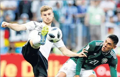  ?? AP PHOTO ?? Germany’s Timo Werner, left, controls the ball against Mexico’s Edson Alvarez during the group F match between Germany and Mexico at the 2018 soccer World Cup in Luzhniki Stadium in Moscow, Russia, Sunday.