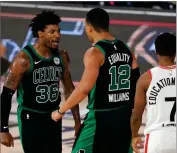  ?? AP PHOTO BY MARK J. TERRILL ?? Boston Celtics’ Marcus Smart (36) celebrates with Grant Williams (12) after sinking a basket and drawing a foul in the second half of an NBA conference semifinal playoff basketball game as Toronto Raptors’ Kyle Lowry looks on Tuesday, Sept. 1, 2020, in Lake Buena Vista, Fla.