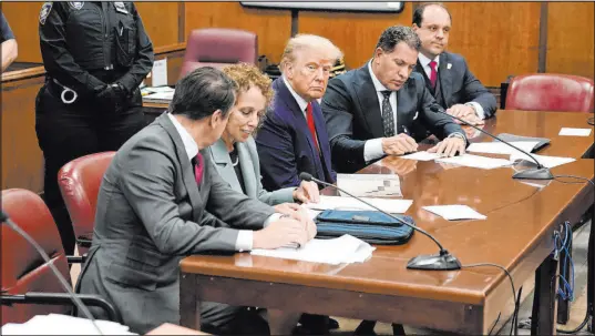  ?? Seth Wenig The Associated Press ?? Former President Donald Trump, center, appears in court for his arraignmen­t in New York on April 4, 2023.