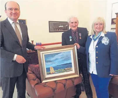  ??  ?? Murray Haddow presents a painting of the monument to Arctic convoy dead to Russia’s Consul General Andrey Pritsipov at a ceremony in Edinburgh, alongside the artist Fiona Haddow.