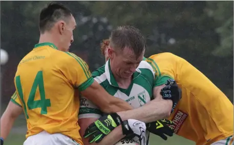  ??  ?? Jeff Scally of Volunteers cannot find a gap to get past Clongeen duo Shane Cahill and Robert Farrell.