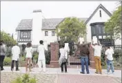  ??  ?? PROTESTERS hold pictures of Ezell Ford, a mentally ill man shot by police in South L.A. last summer.