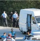  ?? THE ASSOCIATED PRESS ?? Police bomb squad officers work by a road Monday near Subirats, Spain. A fugitive in the city’s van attack has been captured.