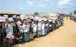  ?? — AP ?? Rohingya refugees hold placards and wait for the arrival of a UN Security Council team at the Kutupalong Rohingya refugee camp in Kutupalong, Bangladesh, on Sunday. The UNSC team visiting Bangladesh promised on Sunday to work hard to resolve a crisis...