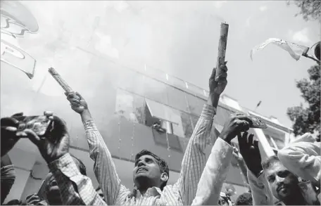  ?? Sanjay Kanojia AFP/Getty Images ?? BHARATIYA Janata Party supporters celebrate as state assembly votes are counted in Lucknow, capital of India’s Uttar Pradesh state.