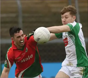  ?? Kilmaine’s goal scorer Michael Hession contests the ball with Na Gaeil’s Damien Bourke. Photo by David Farrell ??