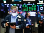  ?? (AP/New York Stock Exchange/Nicole Pereira) ?? Trader Edward McCarthy works Monday on the floor of the New
York Stock Exchange.