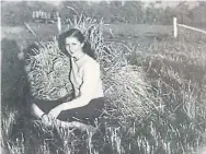  ??  ?? Alda sits on a haystack at the family farm in Gimli, Man., as a teenager. Alda plays with three of her children at the farm.