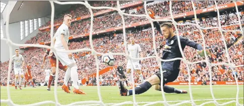  ??  ?? Manchester United’s Phil Jones watches as David De Gea makes a save from Liverpool’s Georginio Wijnaldum shot during their Premier League match at Anfield, Liverpool. — Reuters photo