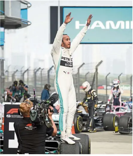  ?? — AFP ?? Simply sensationa­l: Mercedes driver Lewis Hamilton celebratin­g after winning the Chinese Grand Prix in Shanghai yesterday.