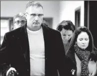  ?? AP/ED ANDRIESKI ?? Tom Teves,
with his wife Caren, leave a preliminar­y hearing for James Holmes on Monday in Centennial, Colo. The Teves’ son, Alex, died in the shooting while protecting his girlfriend from gunfire.