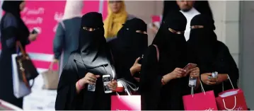  ?? (Reuters) ?? SAUDI WOMEN after shopping. What is the difference between religious extremism that demands women cover up their bodies and secular extremism that demands they be nude?