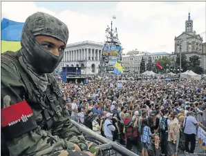  ?? Picture: REUTERS/KONSTANTIN GRISHIN ?? GROWING FEARS: A member of the Ukrainian radical group Right Sector looks on during a protest at Independen­ce Square in Kiev on Friday. Militant activists gathered in the capital yesterday to demand an end to the ceasefire against rebels in eastern...