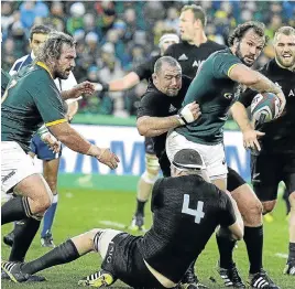  ?? Picture: RAYMOND PRESTON ?? KEEP GOING, OU BOET: Springbok hooker Bismarck du Plessis, with ball, tries to break through the All Black defence, with his brother Jannie coming up in support during the test match against archrivals New Zealand at Ellis Park in March