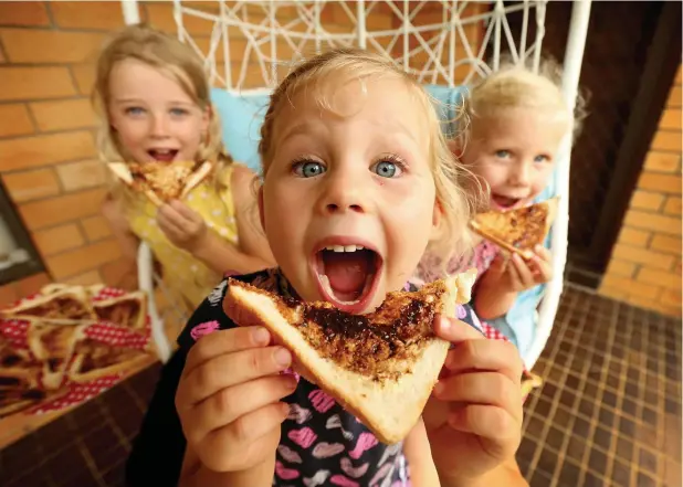  ?? Picture: NATHAN EDWARDS ?? IN AUSSIE HANDS: Charlotte Taylor, Nikki Welsh and Ella Welsh tuck into some Vegemite, which has been bought by Bega Cheese.