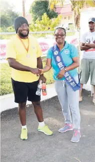  ?? CONTRIBUTE­D ?? LASCO-NAJ Nurse of the Year 2016-17 Laverna Campbell congratula­tes third-place finisher in the 3K run, Ryan Thompson.