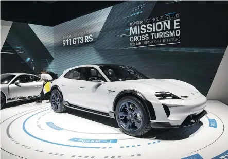  ?? QILAI SHEN/BLOOMBERG FILES ?? VW’s sister brand Porsche showcases its Mission E Cross Turismo all-electric sports car at the Beijing auto exhibit last month. VW is ramping up its e-vehicle offerings with scheduled production of new all-electric SUVs and the four-door coupe Mission E.