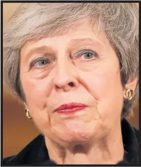  ??  ?? Feeling the strain...Theresa May talks to the press inside No 10 yesterday