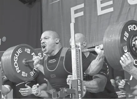  ?? ALIE SKOWRONSKI/COLUMBUS DISPATCH ?? Ashton Rouska, previous powerlifti­ng champion, sets a new American record during powerlifti­ng finals at the 2022 Arnold Sports Festival.