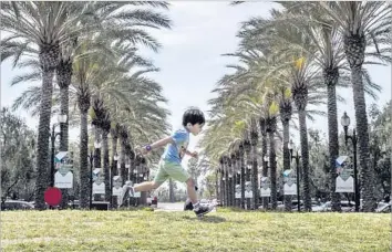  ?? Photograph­s by Allen J. Schaben Los Angeles Times ?? DECADES AGO, critics derided Irvine for its plain suburban feel. Today, the Orange County city boasts a wide mix of cultures and dining options. Above, a boy plays at the Woodbury Town Center.