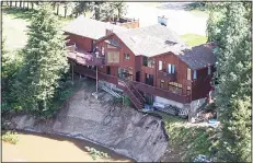  ??  ?? A house sitting on a slope damaged by floodwater­s is seen in Grand Forks, Brtish Columbia on May 12. Thousands of people have been evacuated from their homes in British Columbia’s southern interior as officials warn of flooding due to extremely heavy...