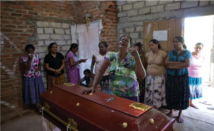  ??  ?? Below: Tears are shed for one of the victims of the Easter Sunday church bombings in Sri Lanka last April, in which 269 people were killed.