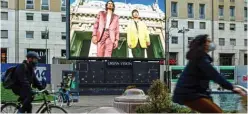  ??  ?? File photo shows a screen displays a broadcast of the Fall/Winter 2021 Men’s fashion collection­s by the Italian Chamber of Italian Fashion (Camera Nazionale della Moda Italiana ) in downtown Milan. — AFP