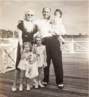  ??  ?? Family members say this vintage silver print of Mae and Al Capone standing on a pier with their grandchild­ren, taken Dec. 25, 1946, is the last photo of him before he died. It’s among the items up for auction Oct. 8.